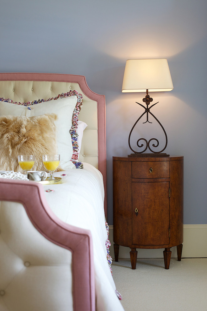Immagine di una camera da letto tradizionale con pareti viola e moquette