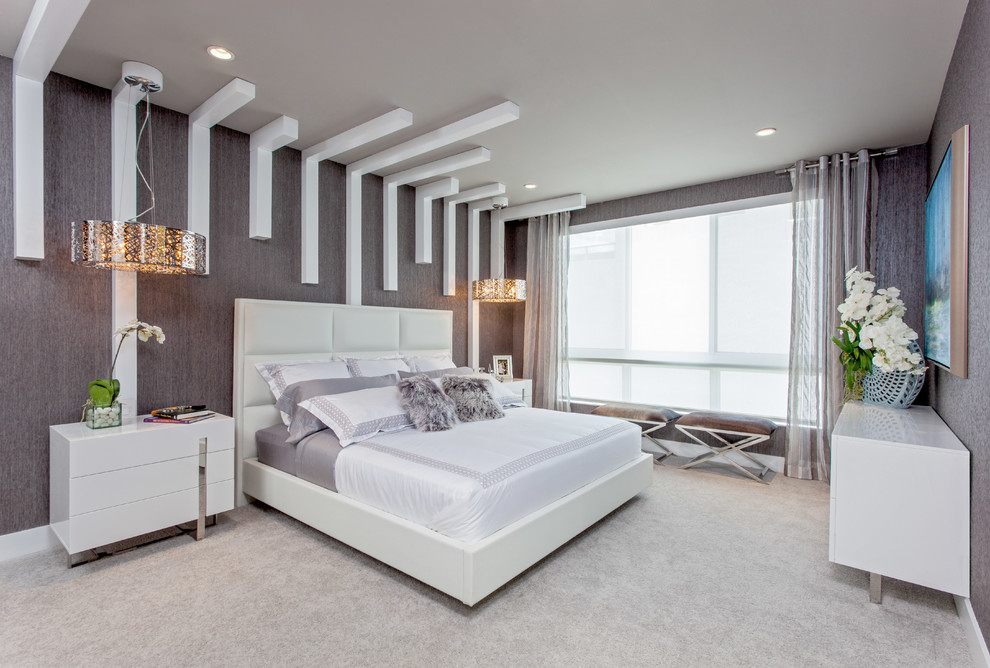 Photo of a large contemporary master bedroom in Miami with grey walls and carpet.