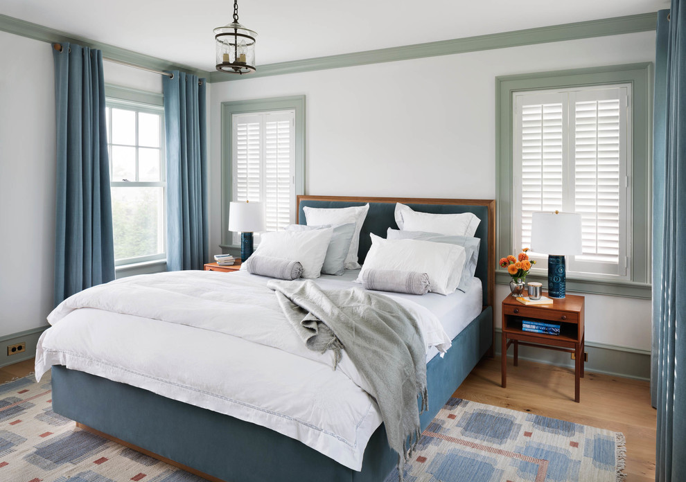 Design ideas for a medium sized coastal guest bedroom in New York with white walls and light hardwood flooring.
