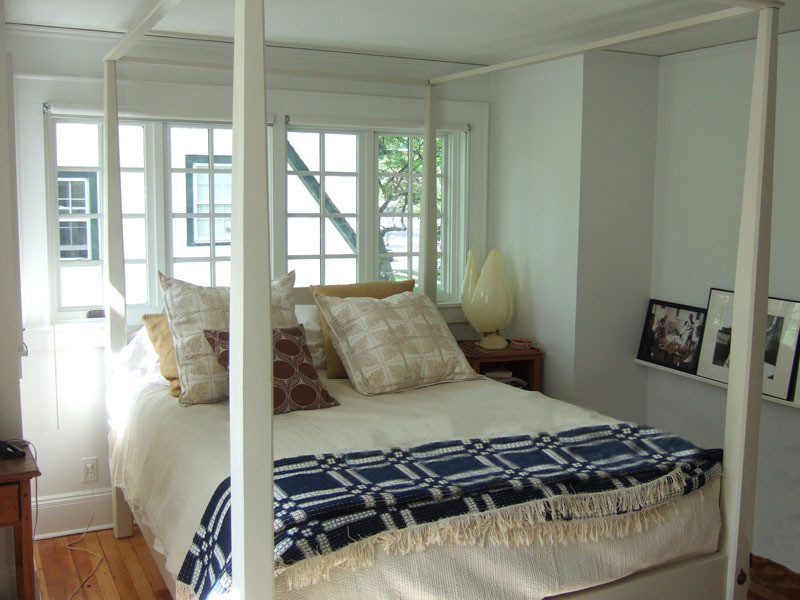 Example of a small classic guest light wood floor bedroom design in New York with blue walls