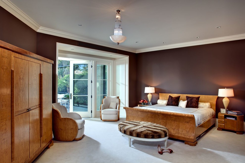 This is an example of a large traditional master bedroom in Miami with red walls and carpet.