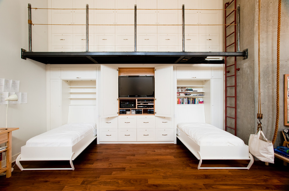 Foto de habitación de invitados industrial con paredes blancas, suelo de madera en tonos medios y con escritorio