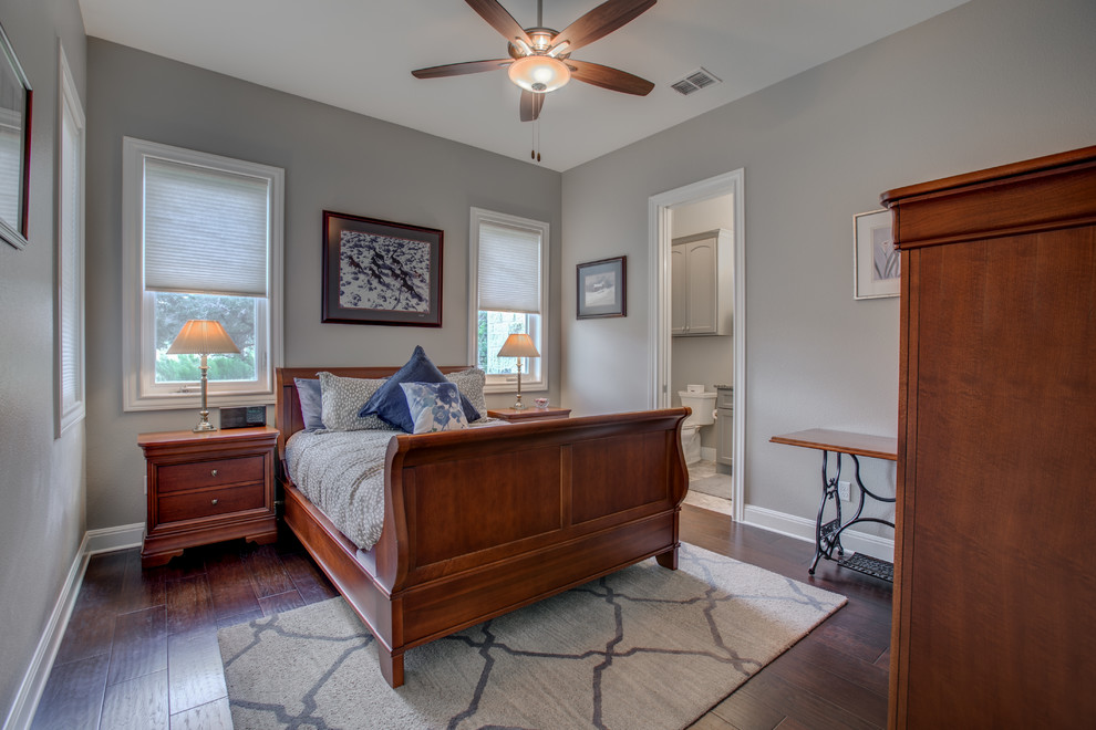 Imagen de habitación de invitados clásica de tamaño medio sin chimenea con paredes grises, suelo de madera oscura y suelo gris