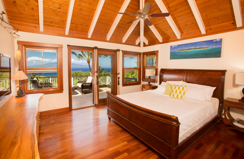 Medium sized world-inspired master bedroom in Hawaii with beige walls and medium hardwood flooring.
