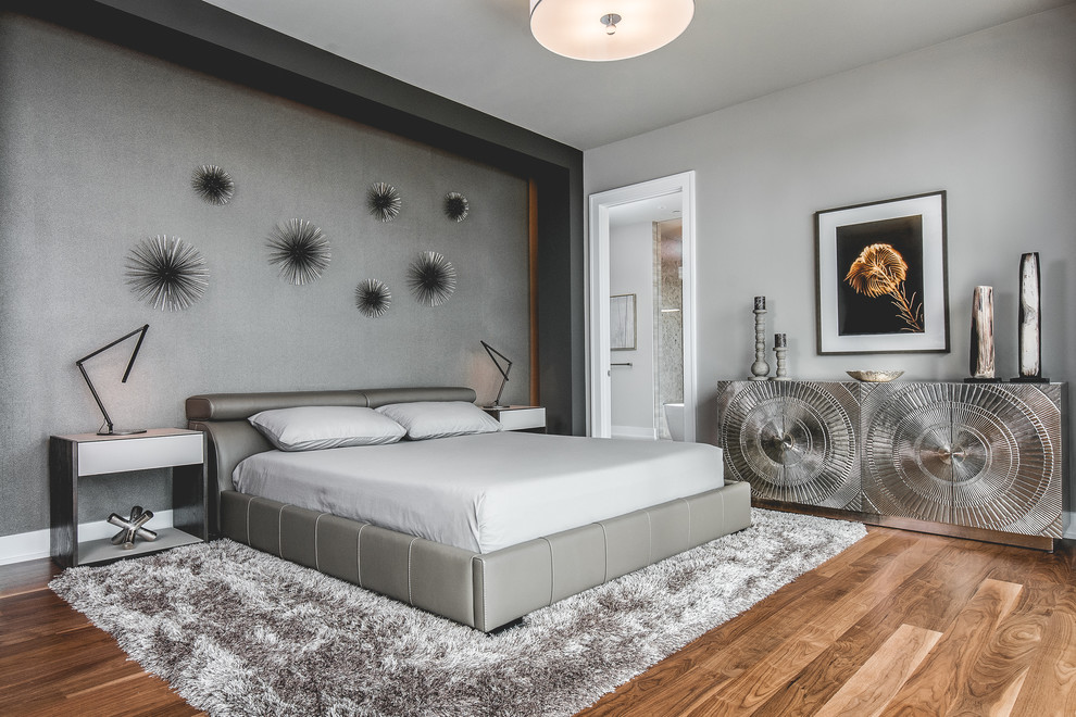 This is an example of a large contemporary master and grey and brown bedroom in Toronto with grey walls, medium hardwood flooring, no fireplace and brown floors.