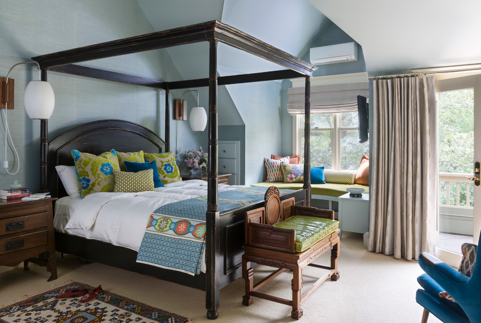 This is an example of an eclectic bedroom in Denver with blue walls and carpet.