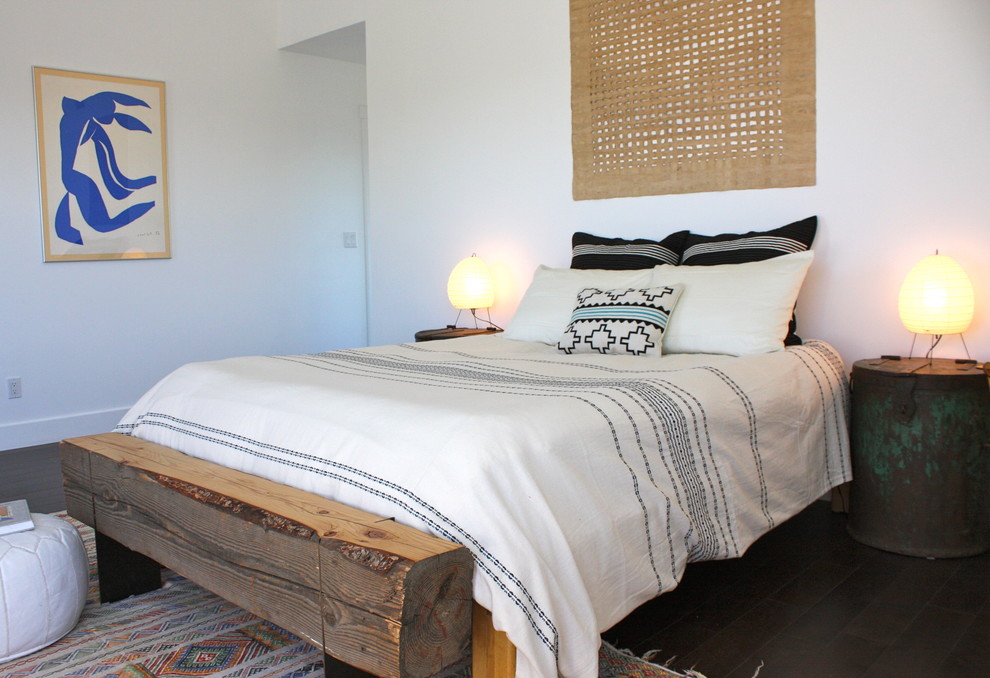 Inspiration for an eclectic bedroom in Los Angeles with white walls and dark hardwood flooring.