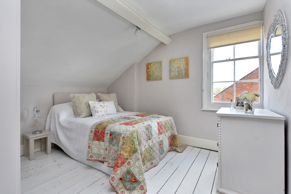 Inspiration for a shabby-chic style guest bedroom in Other with beige walls, painted wood flooring and white floors.