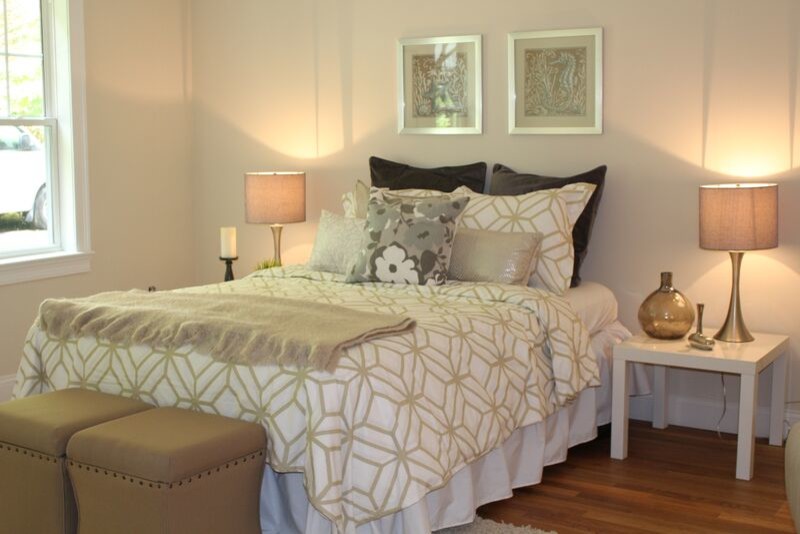 Large transitional master medium tone wood floor bedroom photo in Boston with beige walls