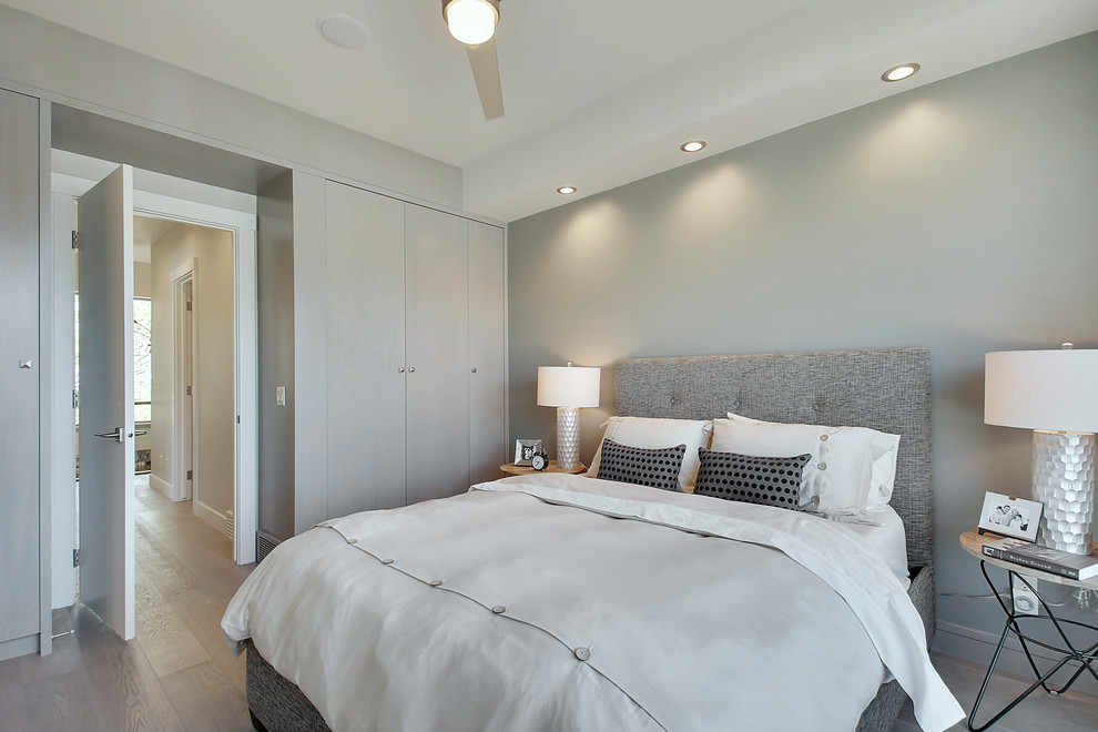 На фото: хозяйская спальня среднего размера в современном стиле с серыми стенами, паркетным полом среднего тона и серым полом с