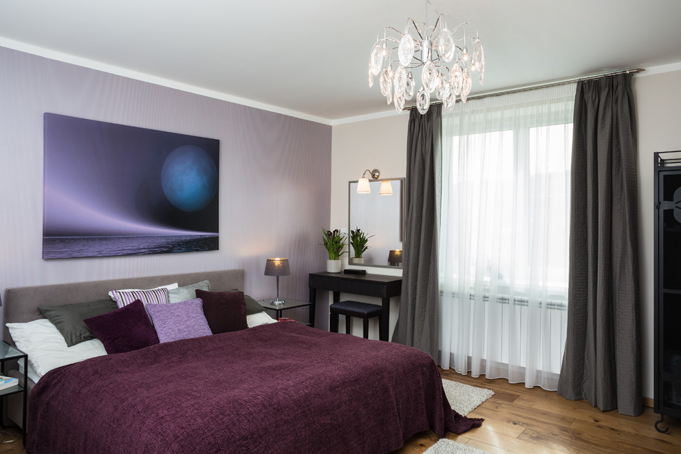 Trendy medium tone wood floor bedroom photo in Other with purple walls
