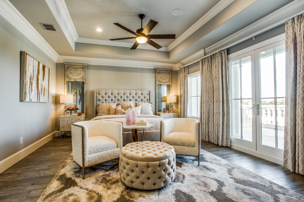 Large traditional master bedroom in Dallas with beige walls, dark hardwood flooring, no fireplace and brown floors.