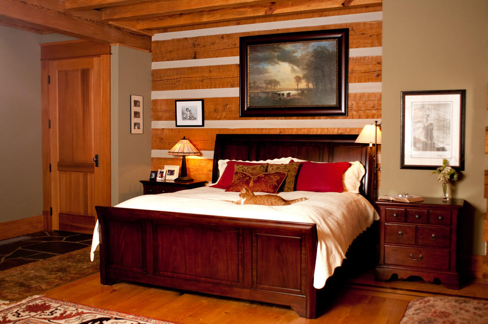 Photo of a large rustic master bedroom in Portland with beige walls and light hardwood flooring.