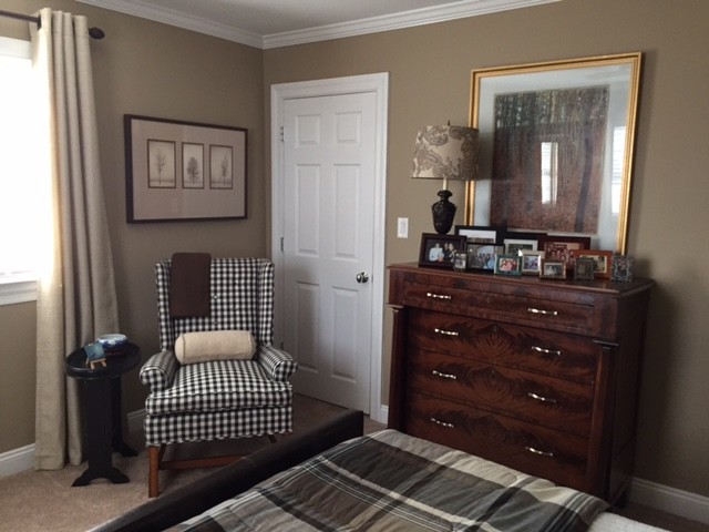 Medium sized country guest bedroom in New York with beige walls and carpet.