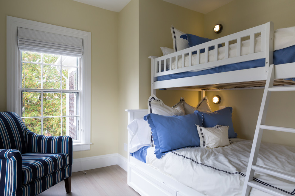 Elegant guest light wood floor and beige floor bedroom photo in Boston with yellow walls