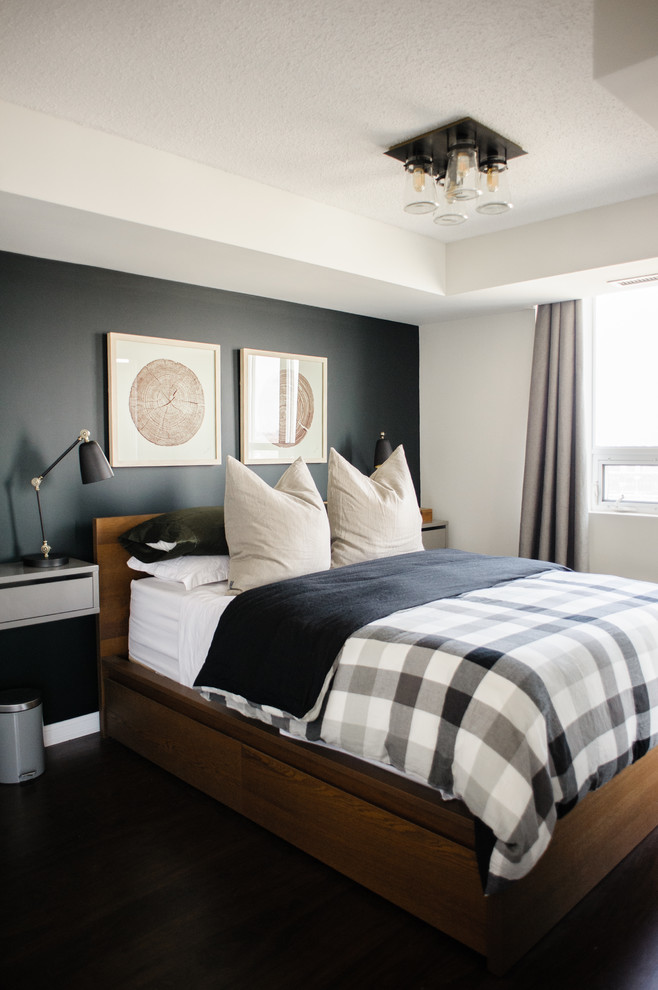 Small classic master and grey and brown bedroom in Toronto with black walls, medium hardwood flooring, no fireplace and brown floors.