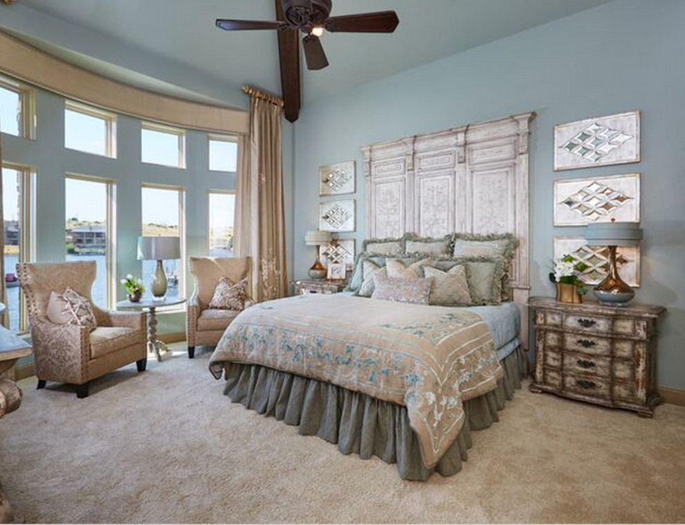 Example of a mid-sized mountain style master carpeted bedroom design in Dallas with blue walls and no fireplace
