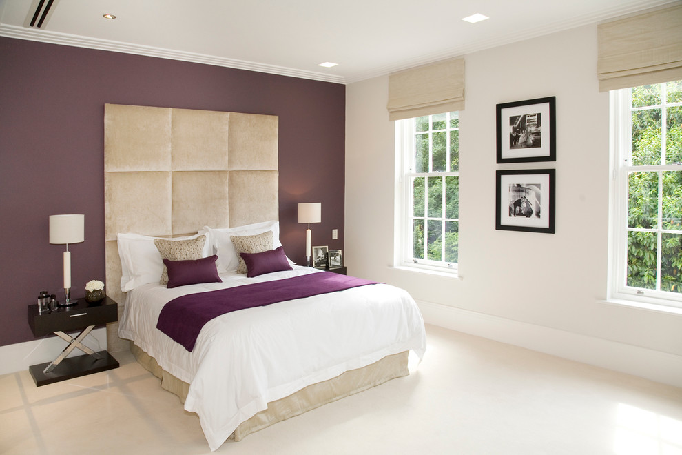 Large contemporary master bedroom in Other with purple walls and carpet.