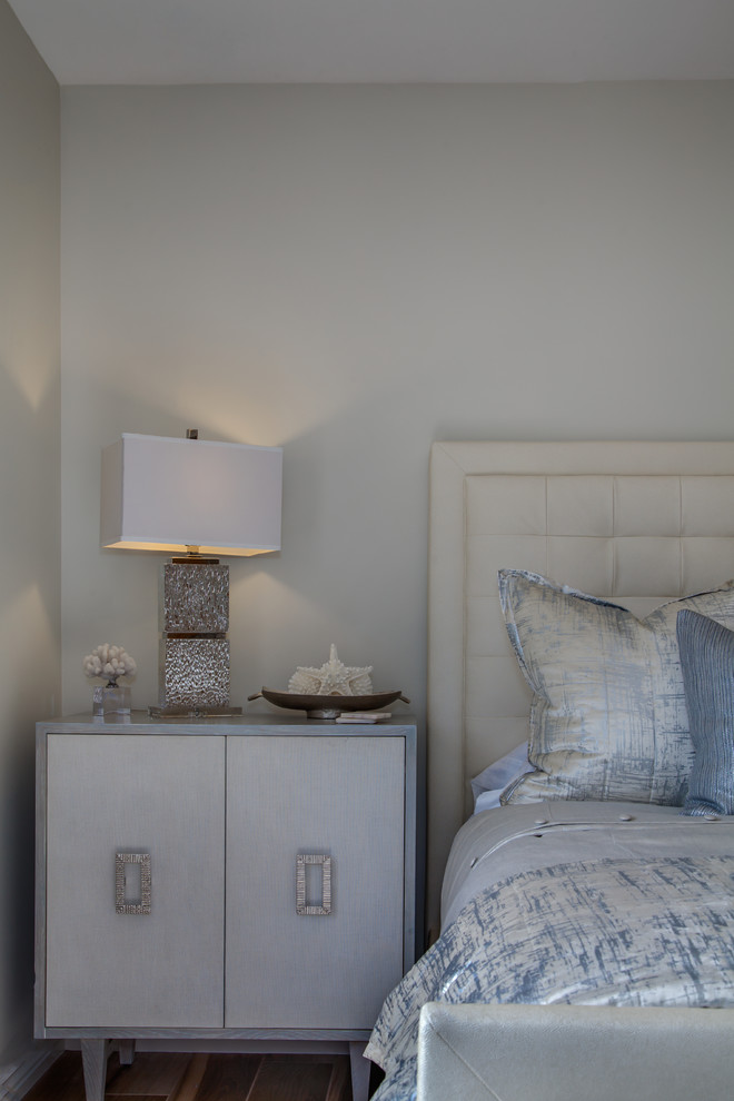 Medium sized beach style guest bedroom in Phoenix with beige walls, medium hardwood flooring and beige floors.
