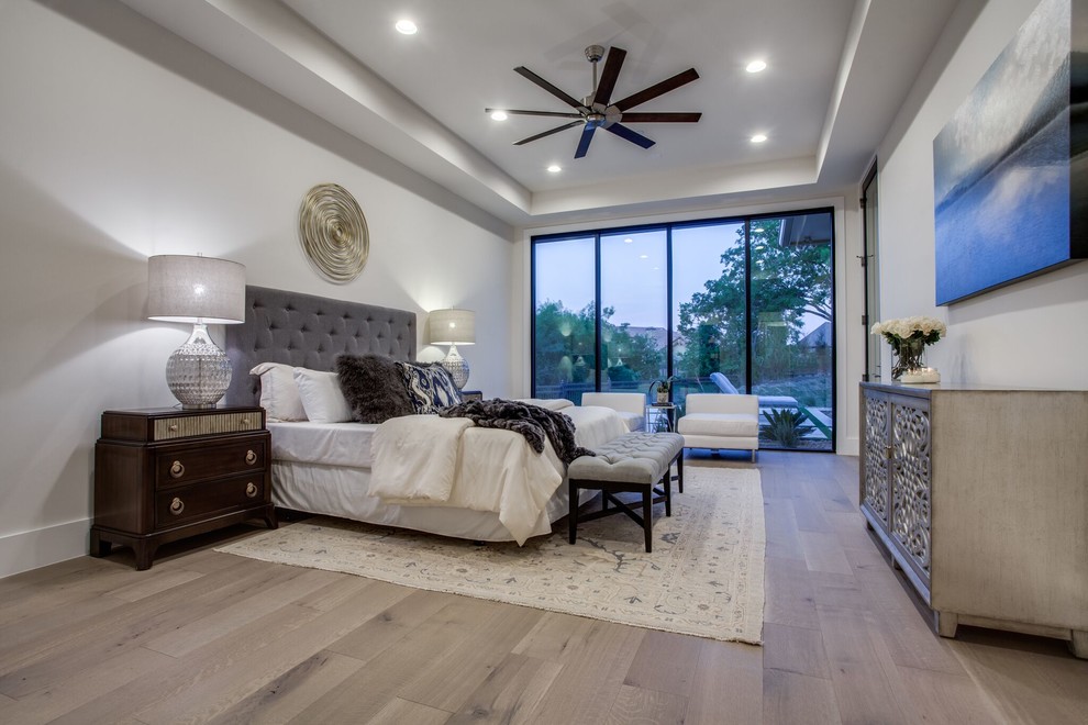 Design ideas for a large traditional master and grey and brown bedroom in Dallas with beige walls, medium hardwood flooring, no fireplace and brown floors.