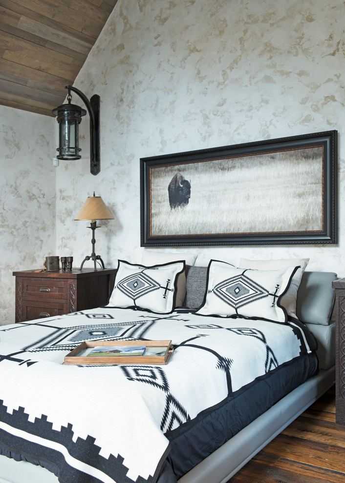 Design ideas for an expansive rustic master bedroom in Other with beige walls and dark hardwood flooring.