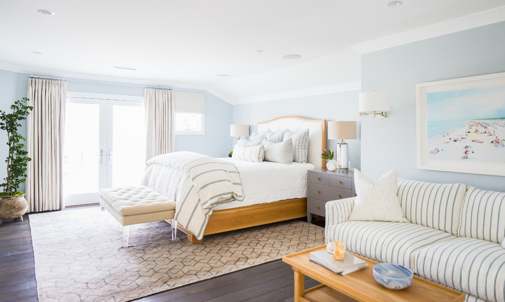 Foto de dormitorio costero con paredes azules, suelo de madera oscura y suelo marrón