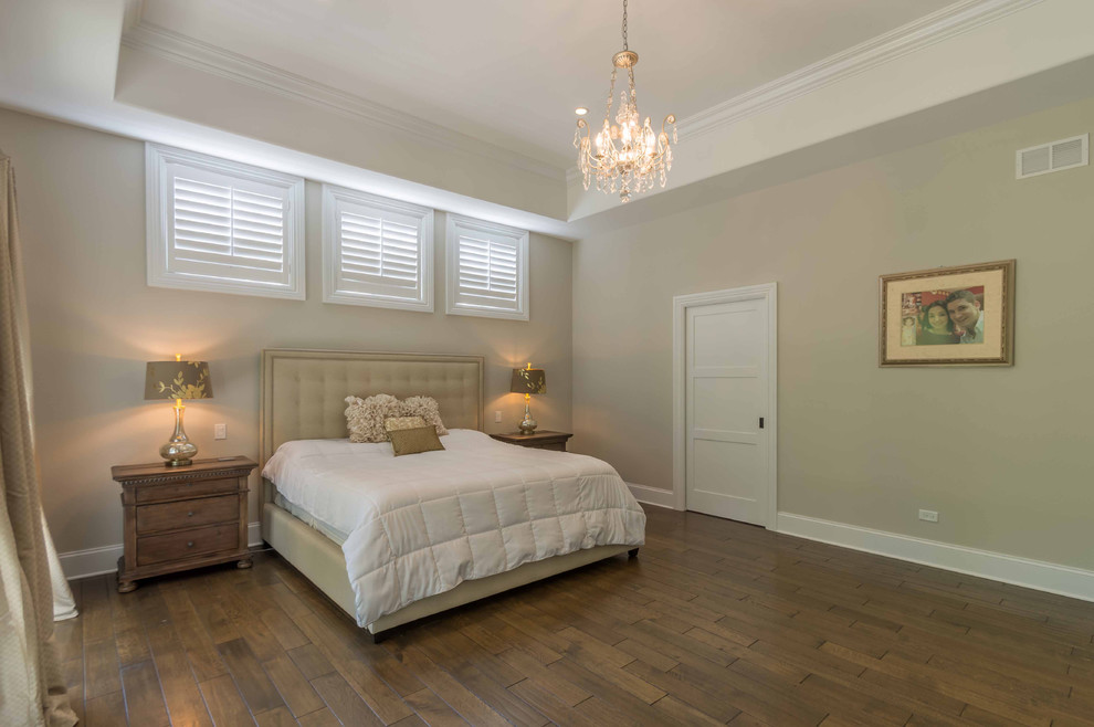 Large classic guest bedroom in Chicago with beige walls, medium hardwood flooring, no fireplace, brown floors, a drop ceiling and wallpapered walls.