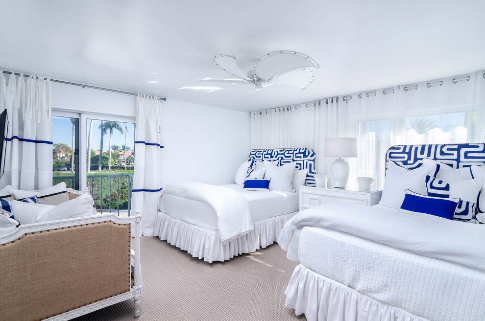 Example of a large beach style guest carpeted and beige floor bedroom design in Miami with white walls and no fireplace