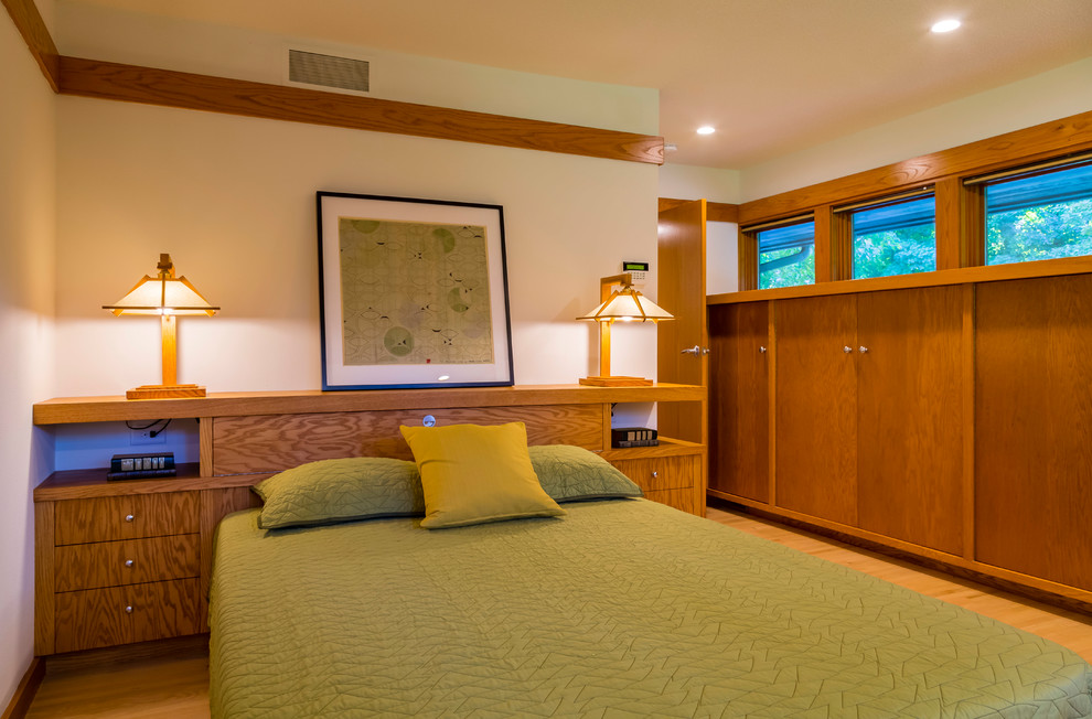 Kleines Rustikales Hauptschlafzimmer ohne Kamin mit weißer Wandfarbe, hellem Holzboden und braunem Boden in Minneapolis