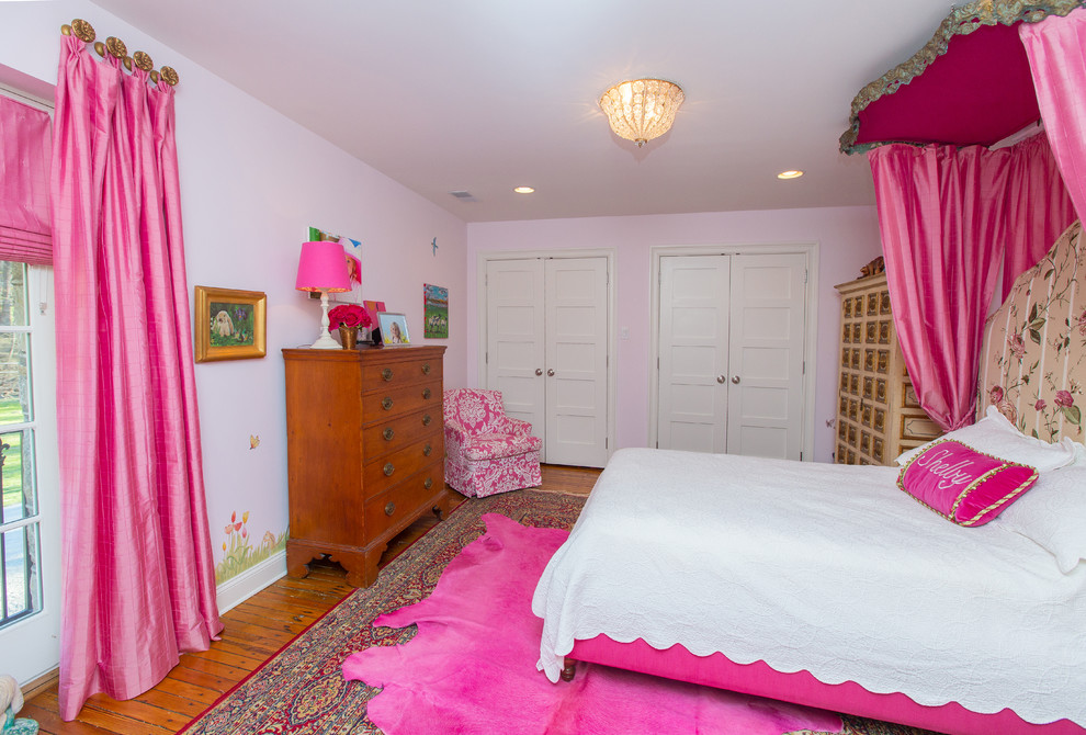 Modelo de dormitorio tradicional de tamaño medio sin chimenea con paredes rosas y suelo de madera en tonos medios