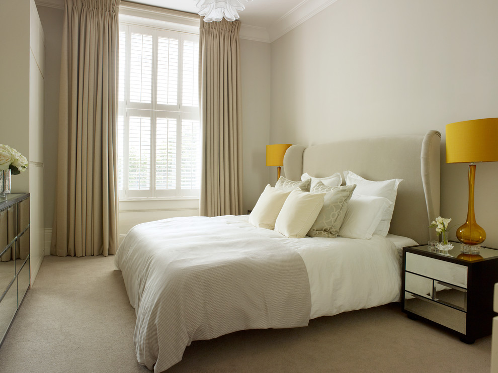Example of a small trendy master carpeted bedroom design in London with beige walls