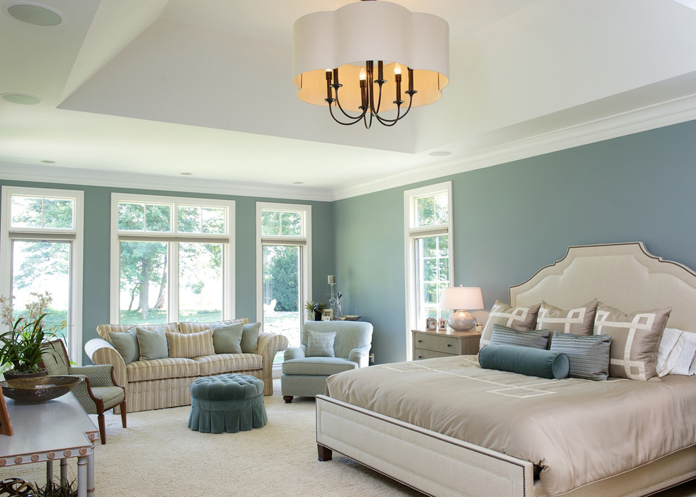 This is an example of a classic grey and cream bedroom in Cleveland with blue walls and carpet.