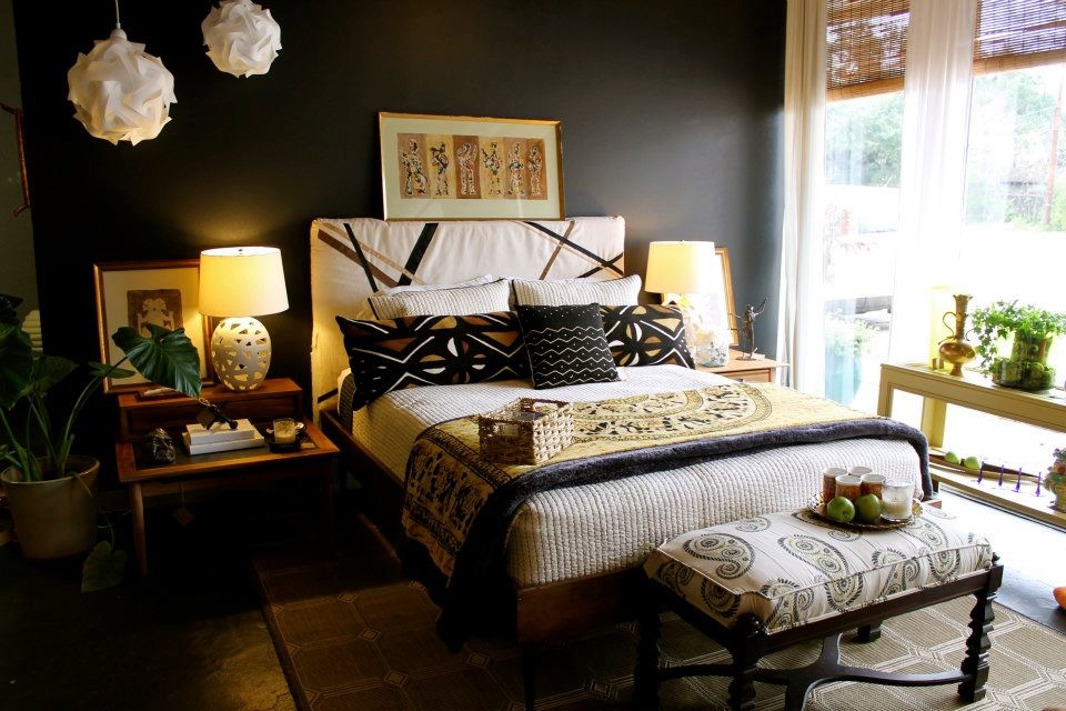 This is an example of a medium sized contemporary guest bedroom in New Orleans with black walls and brown floors.