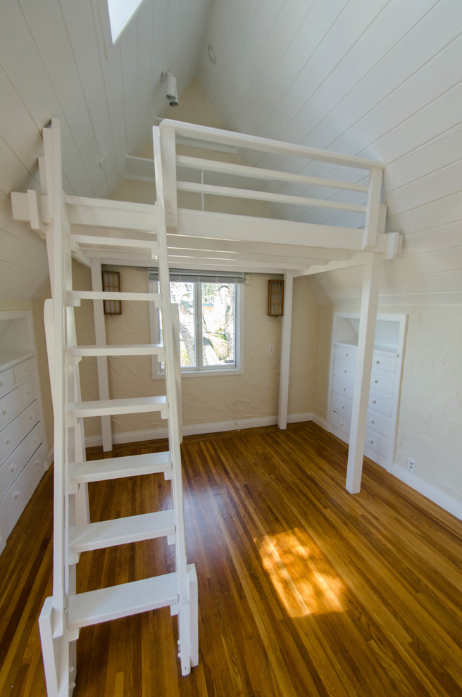 Bedroom - small rustic loft-style medium tone wood floor bedroom idea in San Francisco with white walls