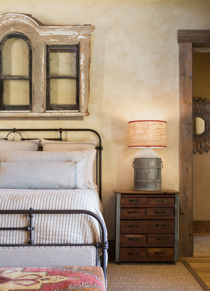 Example of a cottage bedroom design in Austin with beige walls