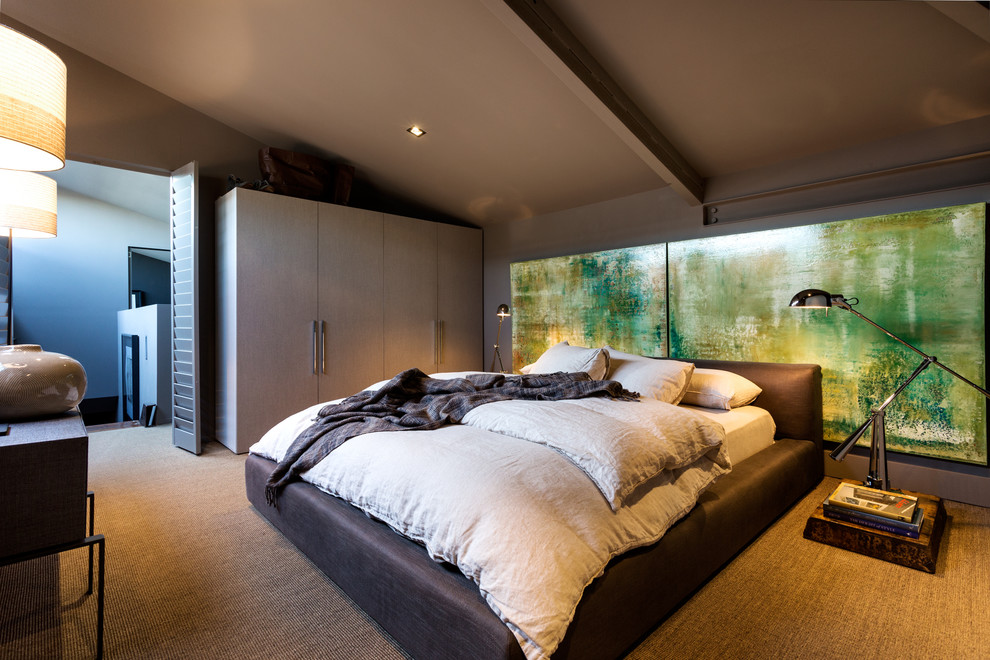 Large contemporary bedroom in Melbourne with grey walls and carpet.