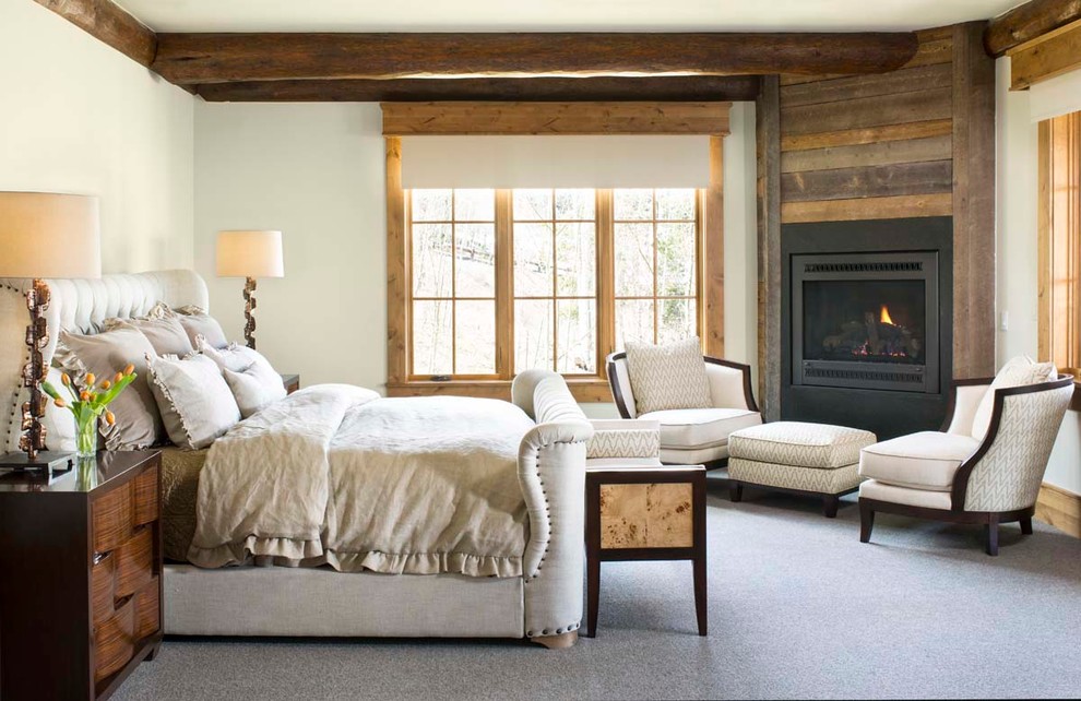 Large rustic master bedroom in Denver with white walls, carpet and a corner fireplace.