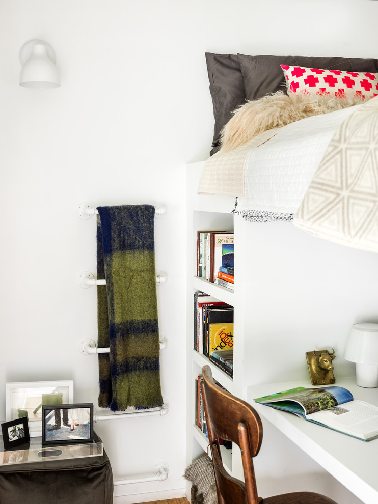 Example of a small trendy loft-style light wood floor bedroom design in Chicago with white walls and no fireplace