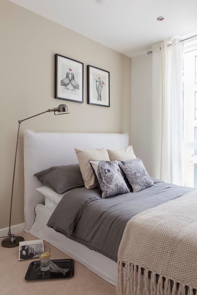 This is an example of a modern grey and cream bedroom in London.