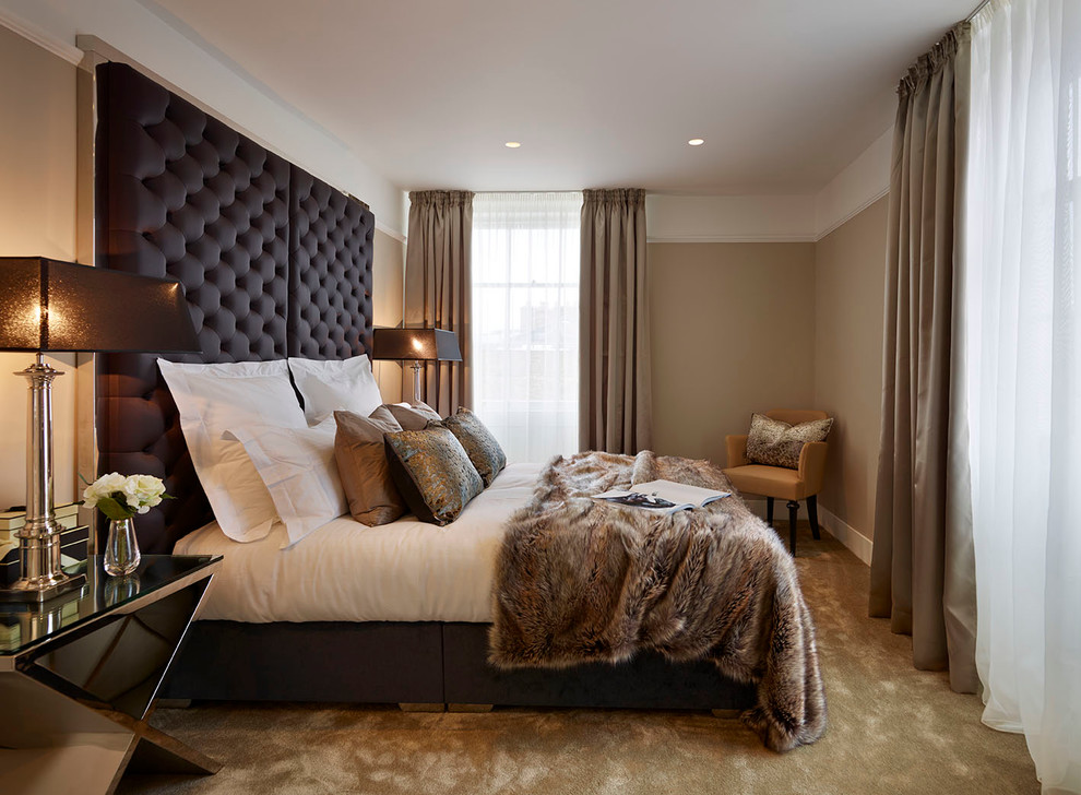 Contemporary bedroom in London with beige walls and carpet.