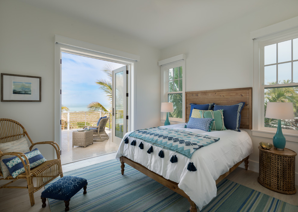 This is an example of a coastal bedroom in Tampa with white walls.