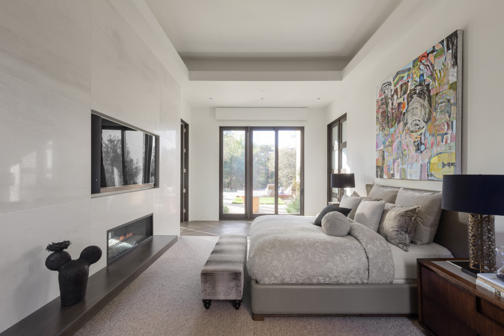 Design ideas for a contemporary master bedroom in Sacramento with white walls and a ribbon fireplace.