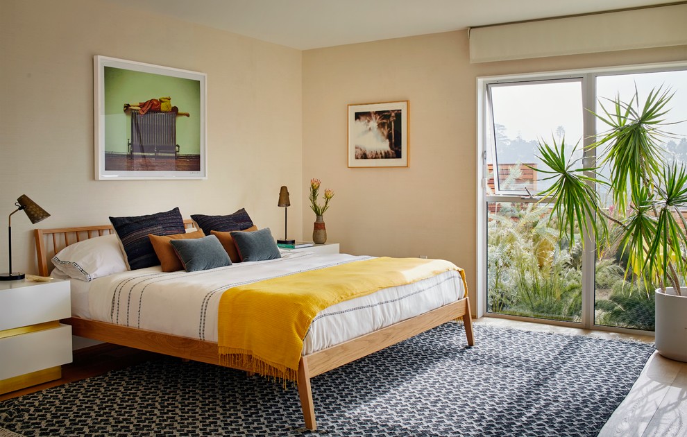 This is an example of a midcentury bedroom in Los Angeles with beige walls and no fireplace.