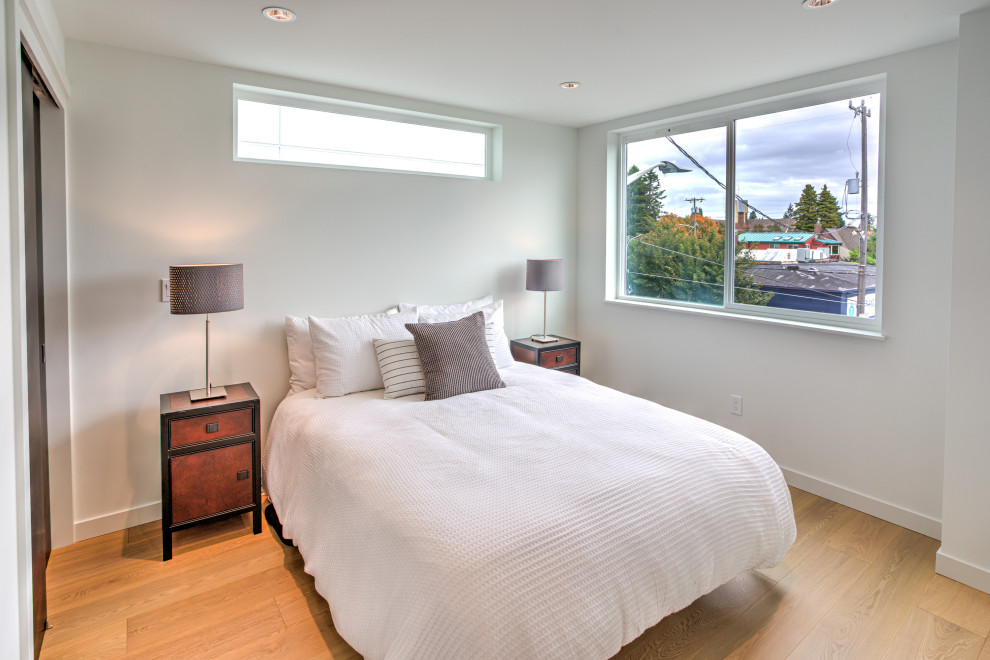 Идея дизайна: гостевая спальня (комната для гостей) в стиле модернизм с белыми стенами и светлым паркетным полом