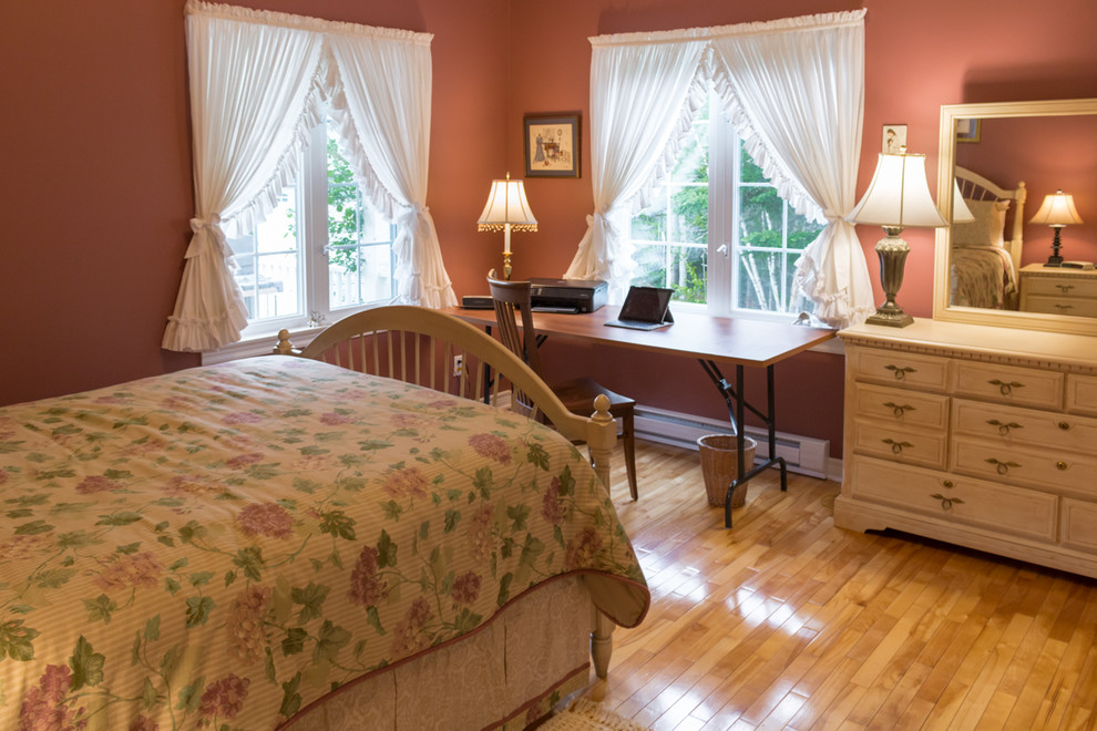 Inspiration for a shabby-chic style guest bedroom in Other with pink walls and light hardwood flooring.