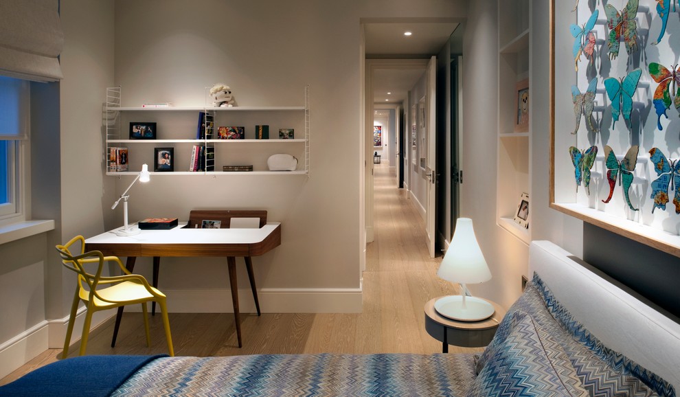 Immagine di una camera degli ospiti minimal di medie dimensioni con pavimento in legno massello medio e pareti grigie
