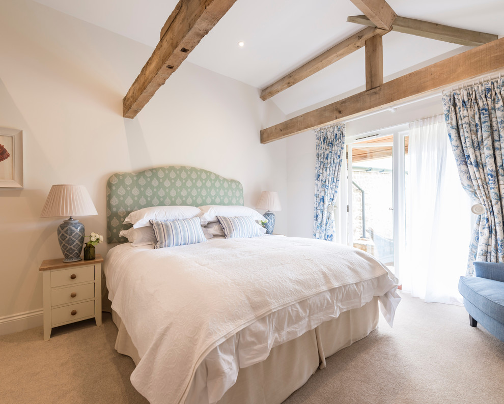 Bedroom - large farmhouse guest carpeted and gray floor bedroom idea in Dorset with white walls