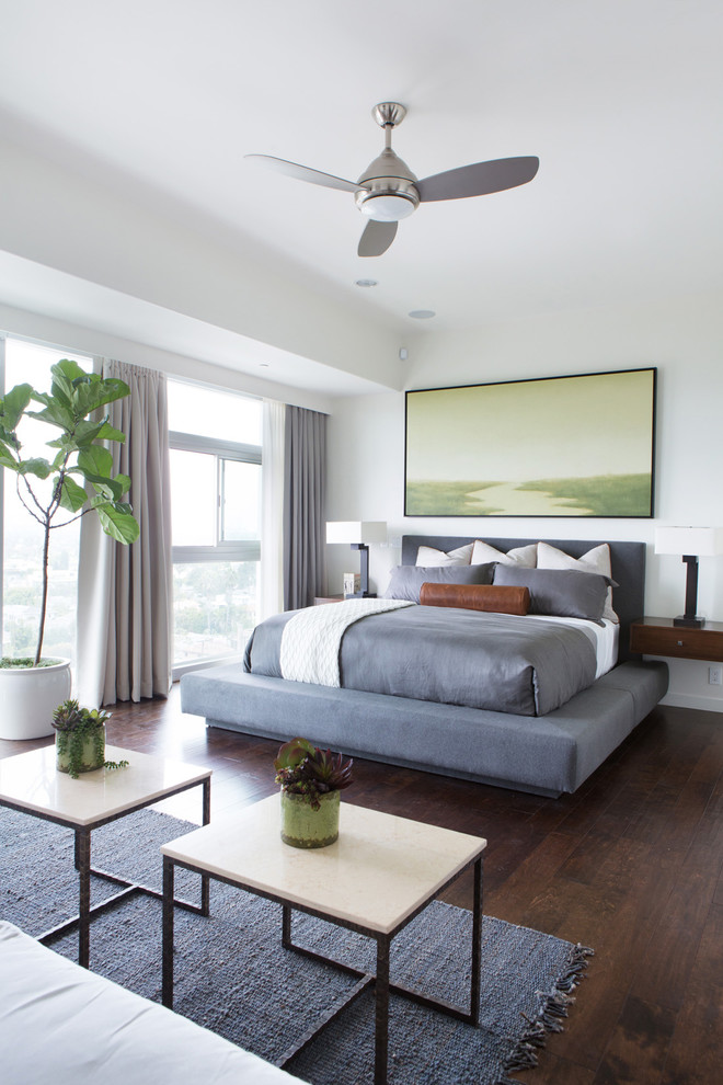 Inspiration for a contemporary bedroom in Los Angeles with white walls and dark hardwood flooring.