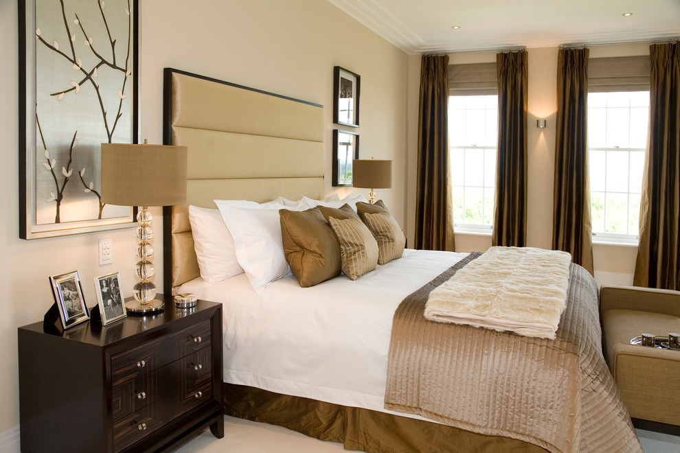 Medium sized contemporary master bedroom in Other with beige walls and carpet.