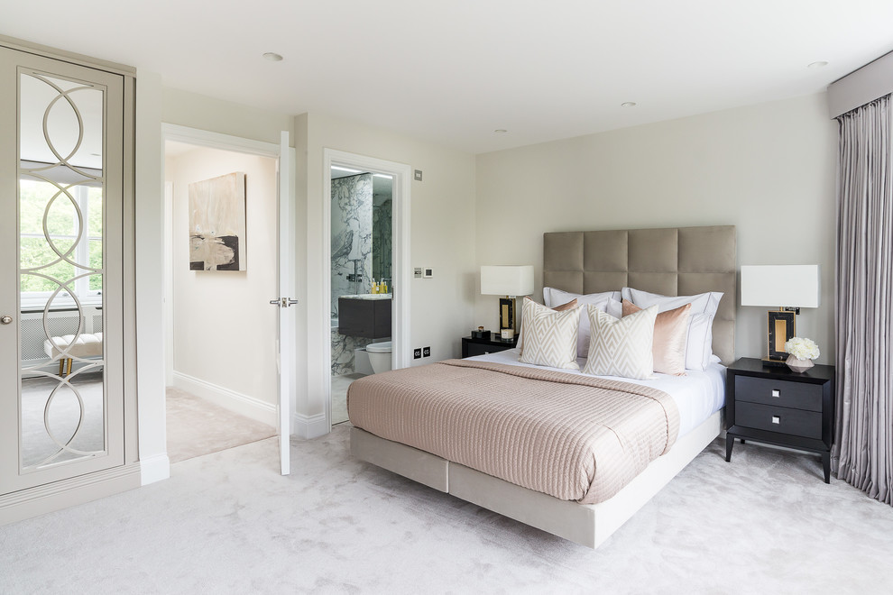 Photo of a medium sized contemporary master and grey and pink bedroom in London with beige walls, carpet and grey floors.